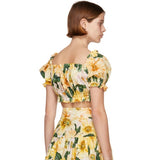 Dolce and Gabbana yellow sunflower print crop top and skirt set, back view on model — Dolce and Gabbana | Endless UAE