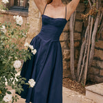 Woman wearing navy blue corset sundress with sweetheart neckline in garden setting — House of CB | Endless UAE