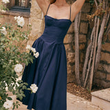 Woman wearing navy blue corset sundress with sweetheart neckline in garden setting — House of CB | Endless UAE