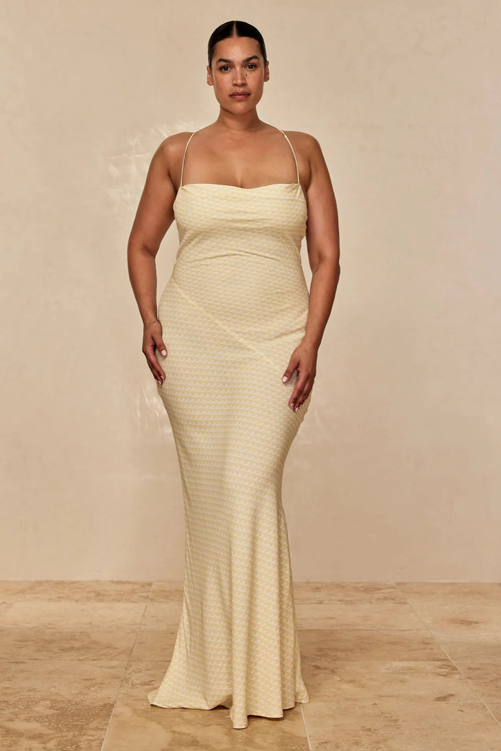 Woman wearing cream textured maxi dress with thin straps and fitted silhouette against neutral background — Monday Swimwear | Endless UAE