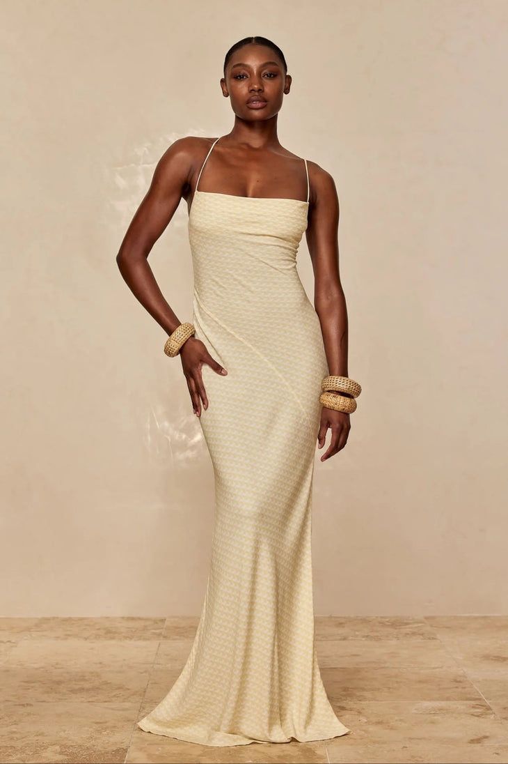 Elegant floor-length slip dress in champagne with thin straps and textured fabric, styled with gold bangles — Monday Swimwear | Endless UAE
