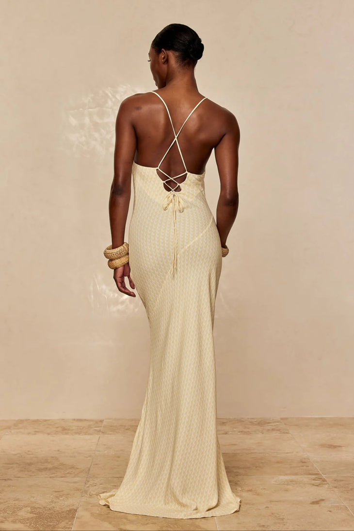 Elegant cream textured maxi dress with open back and delicate criss-cross straps, shown from behind — Monday Swimwear | Endless UAE