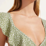 Green floral print ruffle bikini top with tie front detail modeled on woman — Eberjey | Endless UAE