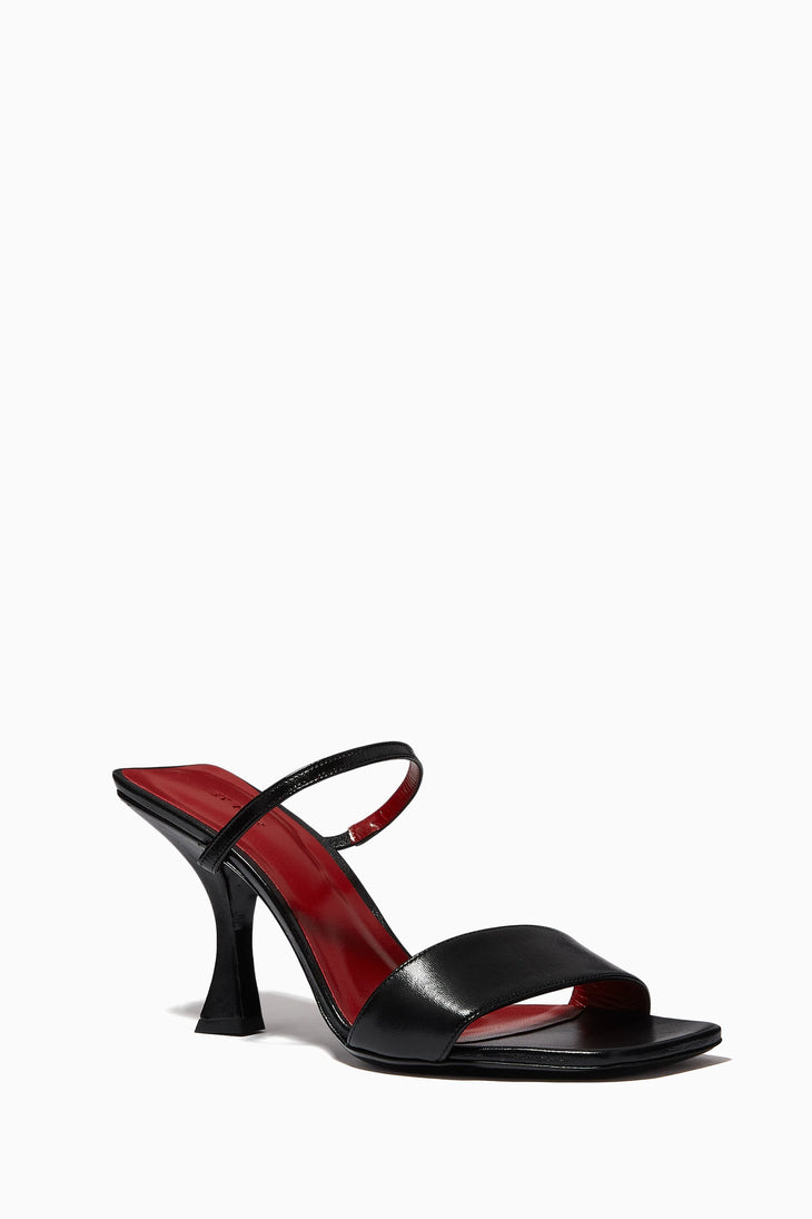 Black leather mules with burgundy insole, square toe, slingback ankle strap, and sculptural flared heel — By Far | Endless UAE