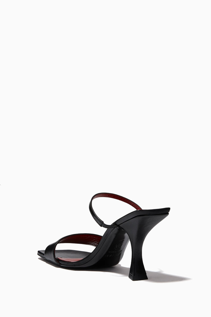 Black leather strappy mules with sculptural flared heel and slingback ankle strap — By Far | Endless UAE