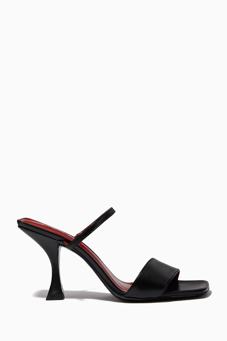 Black leather mule sandals with sculptural flared heel and dual slim straps — By Far | Endless UAE
