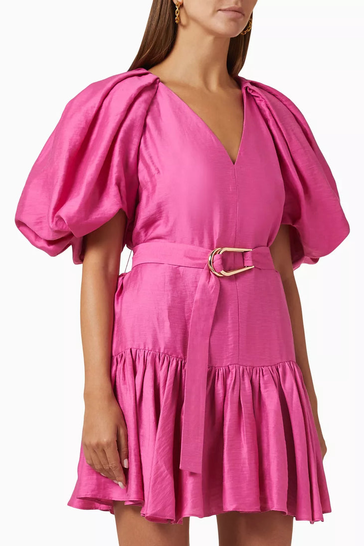 Woman wearing bright pink puff-sleeve mini dress with belt and ruffled hem — Acler | Endless UAE