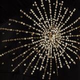Black maxi dress with gold sunburst embellishment and flowing bell sleeves — RIXO | Endless UAE