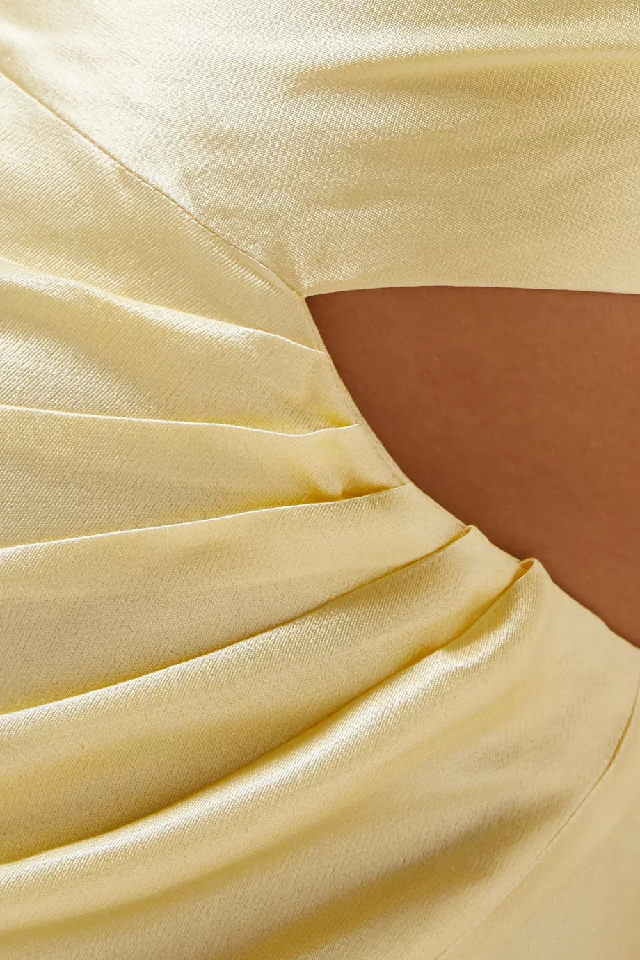 Pale yellow gathered maxi dress fabric detail showing silky texture and draping with skin visible through gathered sections — Shona Joy | Endless UAE