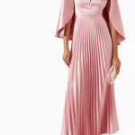 Woman wearing a pink satin pleated dress with matching cape overlay and metallic heels — Nass | Endless UAE
