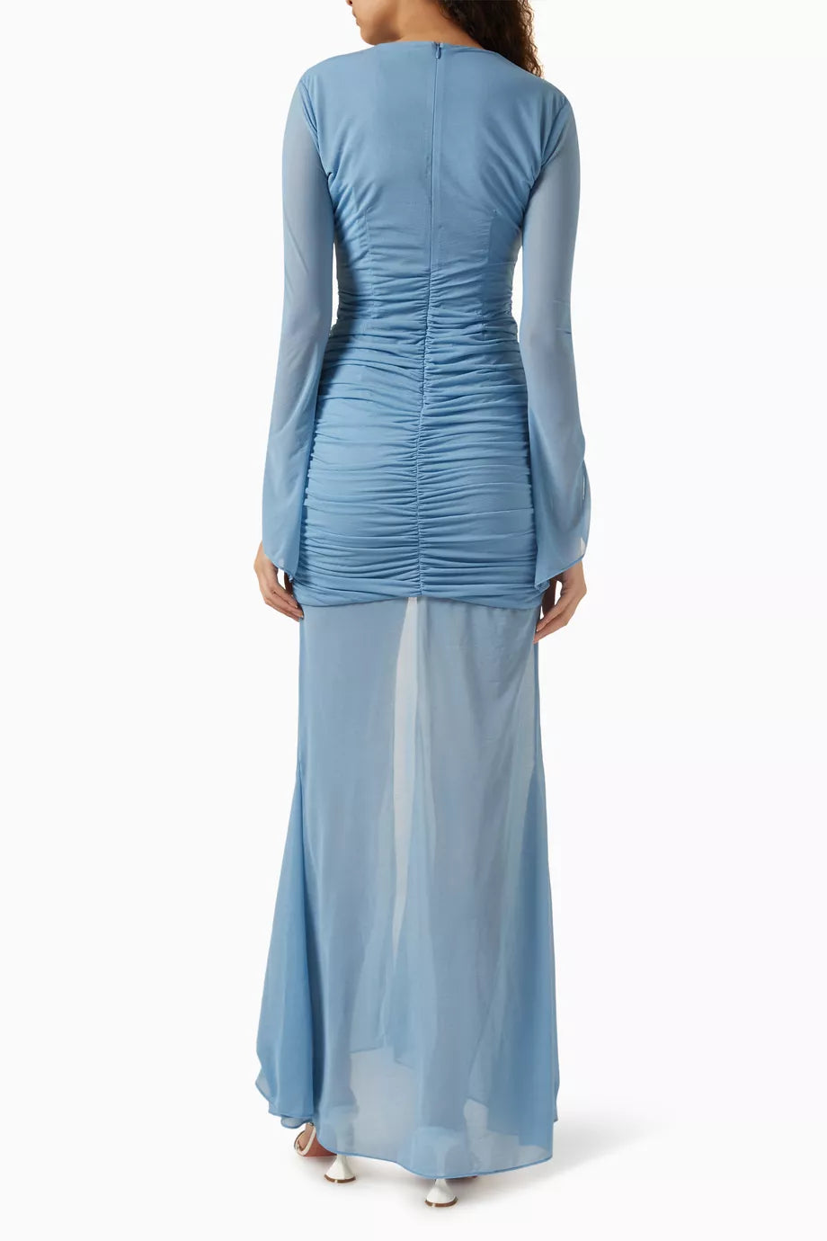 Woman wearing petrol blue long-sleeve maxi dress with ruched detailing and front slit — De La Vali | Endless UAE