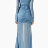 Woman wearing petrol blue long-sleeve maxi dress with ruched detailing and front slit — De La Vali | Endless UAE