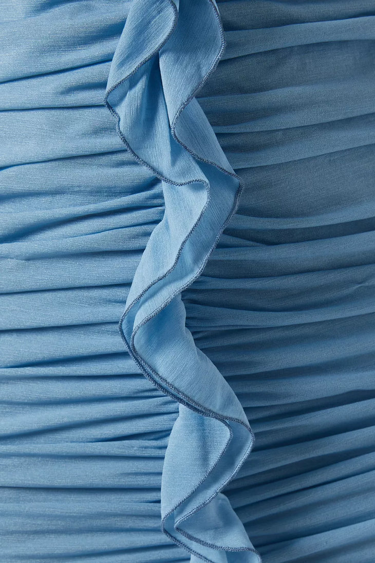 Woman wearing petrol blue long-sleeve maxi dress with ruched detailing and front slit — De La Vali | Endless UAE