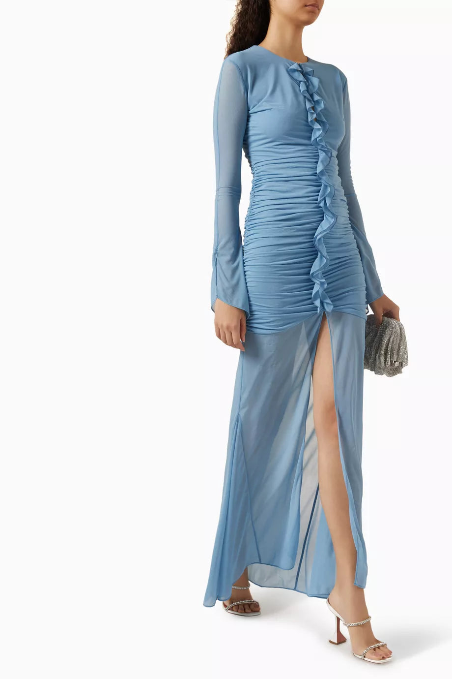 Woman wearing petrol blue long-sleeve maxi dress with ruched detailing and front slit — De La Vali | Endless UAE