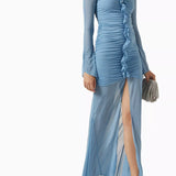 Woman wearing petrol blue long-sleeve maxi dress with ruched detailing and front slit — De La Vali | Endless UAE