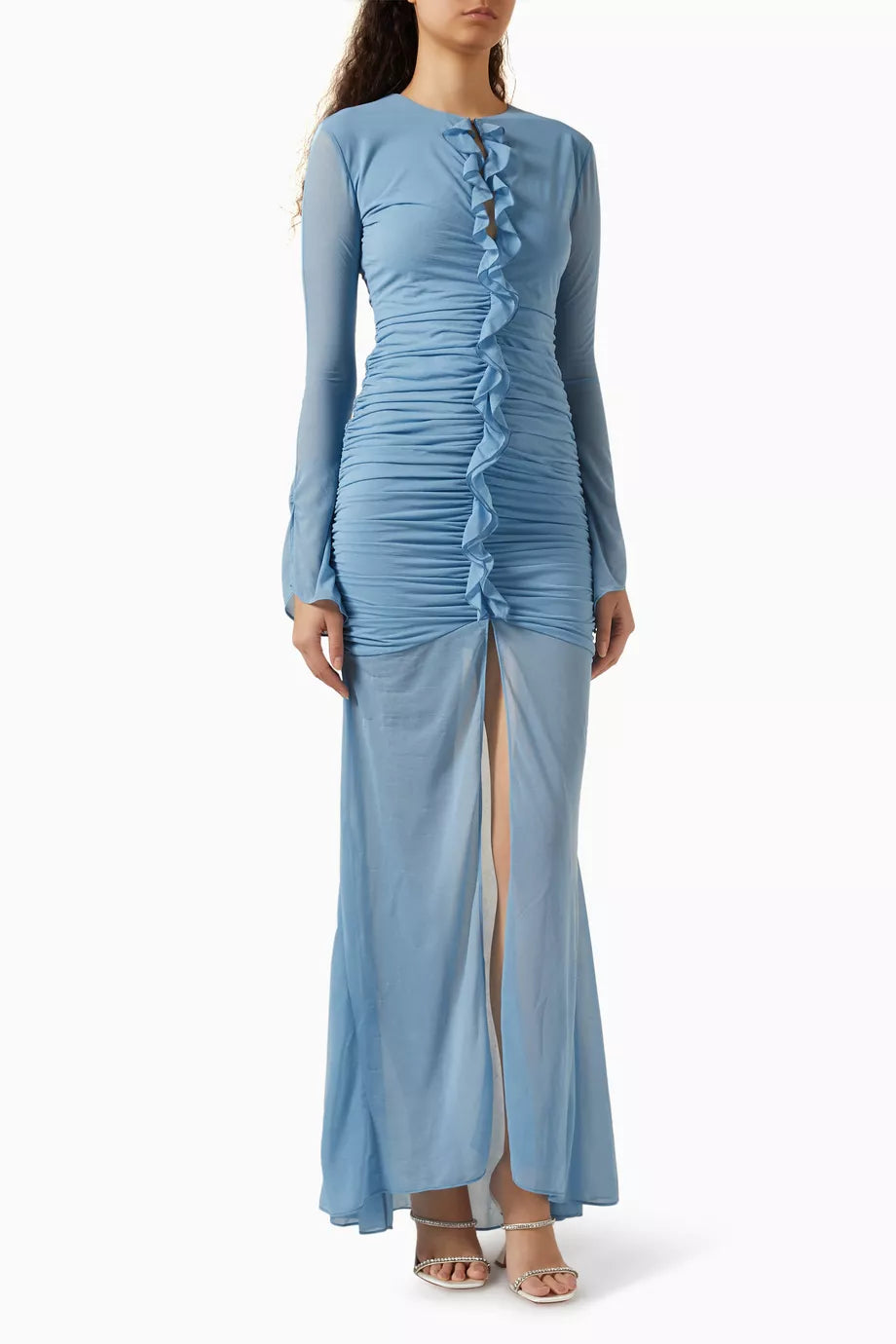 Woman wearing petrol blue long-sleeve maxi dress with ruched detailing and front slit — De La Vali | Endless UAE