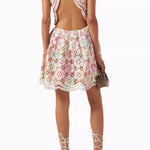 Pastel floral lace mini dress with open back and halter neck worn with white lace-up heels — Elliatt | Endless UAE