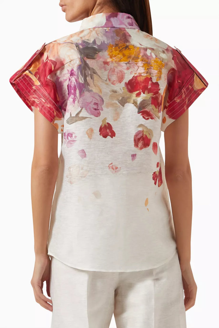Woman wearing floral print blouse and wide-leg pants with brown handbag — Leo Lin | Endless UAE
