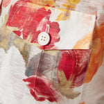 Woman wearing floral print blouse and wide-leg pants with brown handbag — Leo Lin | Endless UAE