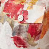 Woman wearing floral print blouse and wide-leg pants with brown handbag — Leo Lin | Endless UAE