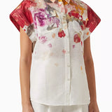 Woman wearing floral print blouse and wide-leg pants with brown handbag — Leo Lin | Endless UAE