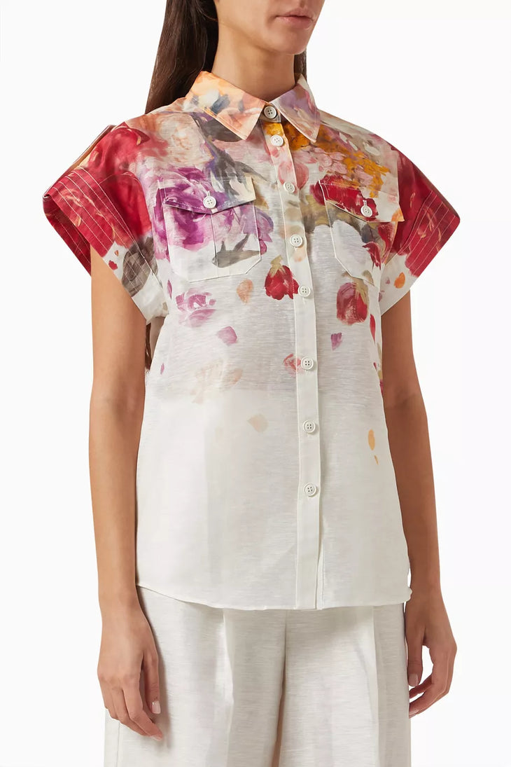 Woman wearing floral print blouse and wide-leg pants with brown handbag — Leo Lin | Endless UAE