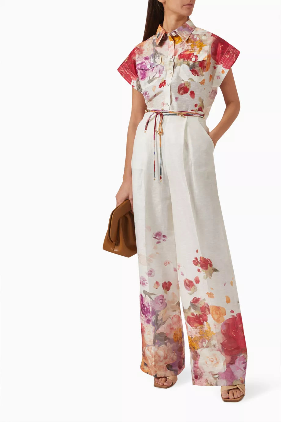 Woman wearing floral print blouse and wide-leg pants with brown handbag — Leo Lin | Endless UAE