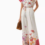 Woman wearing floral print blouse and wide-leg pants with brown handbag — Leo Lin | Endless UAE