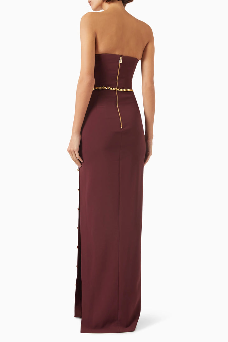 Rear view of burgundy strapless maxi dress with gold chain belt and back zipper — Elisabetta Franchi | Endless UAE
