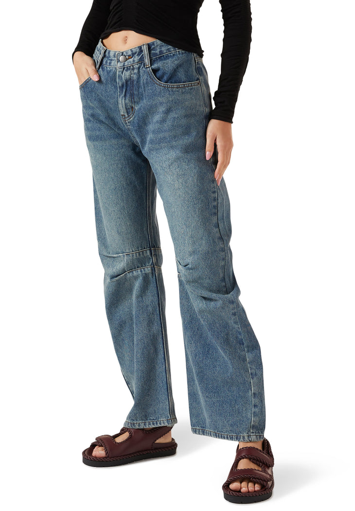 Person wearing medium wash denim jeans with brown woven leather sandals and black long sleeve top — Bottega Veneta | Endless UAE