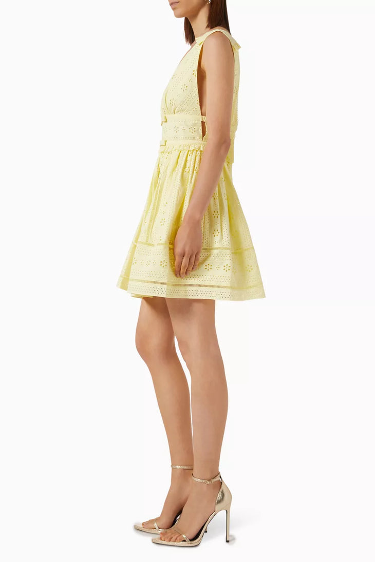 Yellow broderie anglaise mini dress with waist tie detail and bow shoulder straps on model — Self-Portrait | Endless UAE
