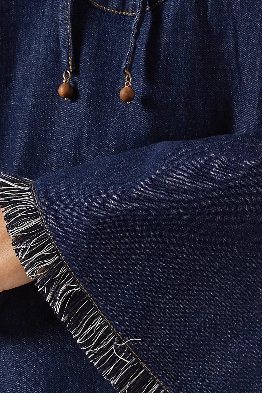 Dark blue denim mini dress with fringe hem detail and wooden bead drawstring ties — Zimmerman | Endless UAE