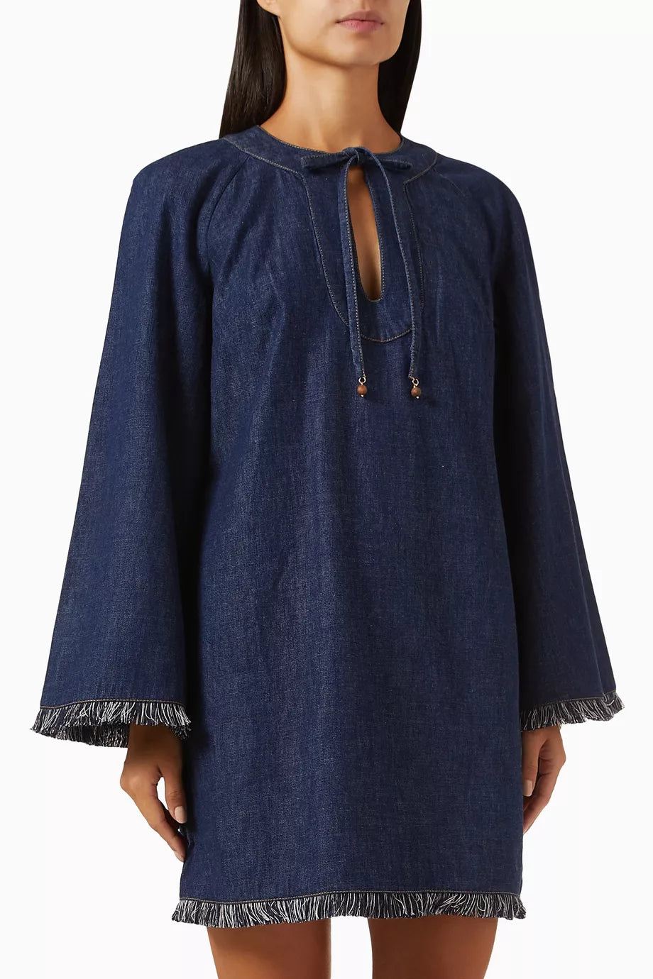 Dark blue denim mini dress with long sleeves, fringe hem detail, and keyhole tie neckline — Zimmermann | Endless UAE