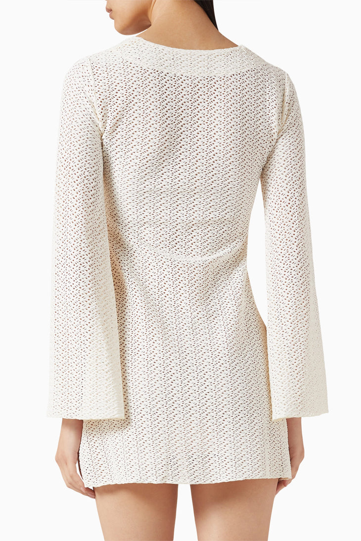 Cream crochet knit mini dress with long sleeves and open weave pattern, back view — Monday Swimwear | Endless UAE
