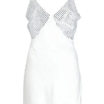 White slip dress with studded chest panel worn with yellow clutch and black sandals — De La Vali | Endless UAE