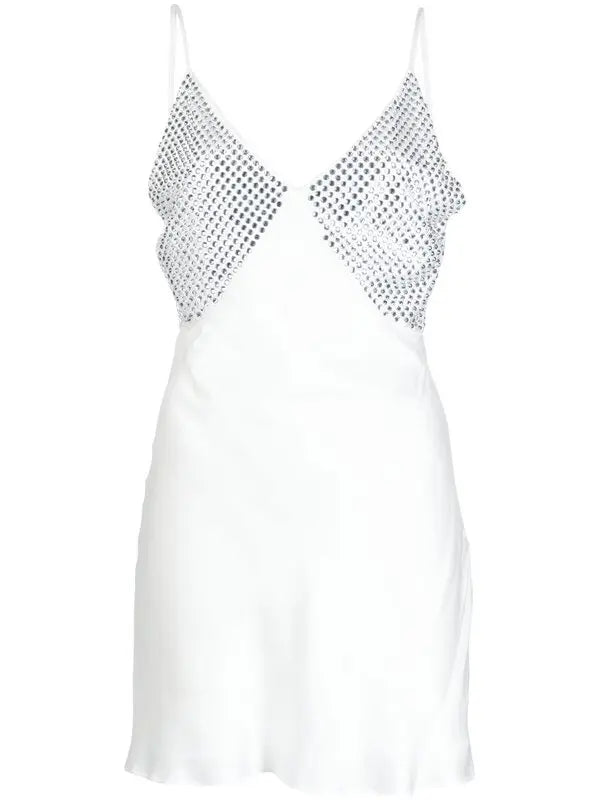 White slip dress with studded chest panel worn with yellow clutch and black sandals — De La Vali | Endless UAE