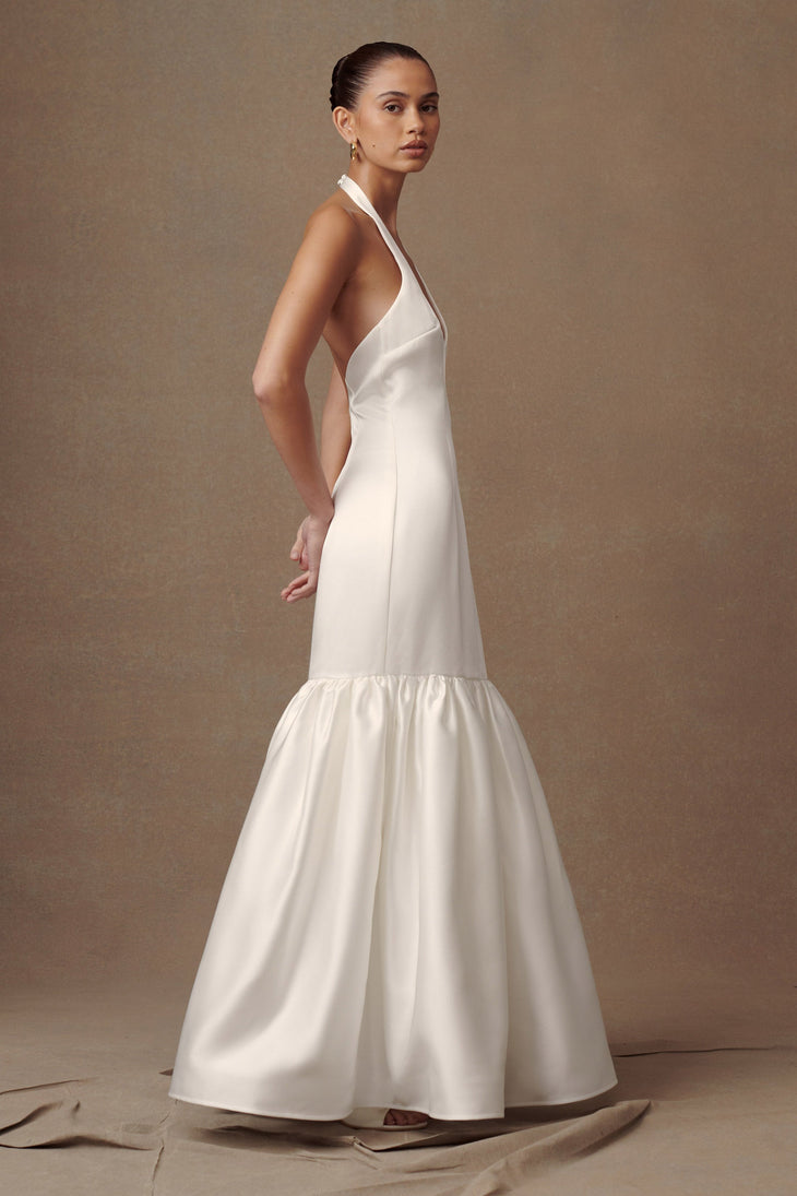 Elegant white satin halter gown with plunging neckline and tiered mermaid skirt, perfect for weddings and formal events — Meshki | Endless UAE