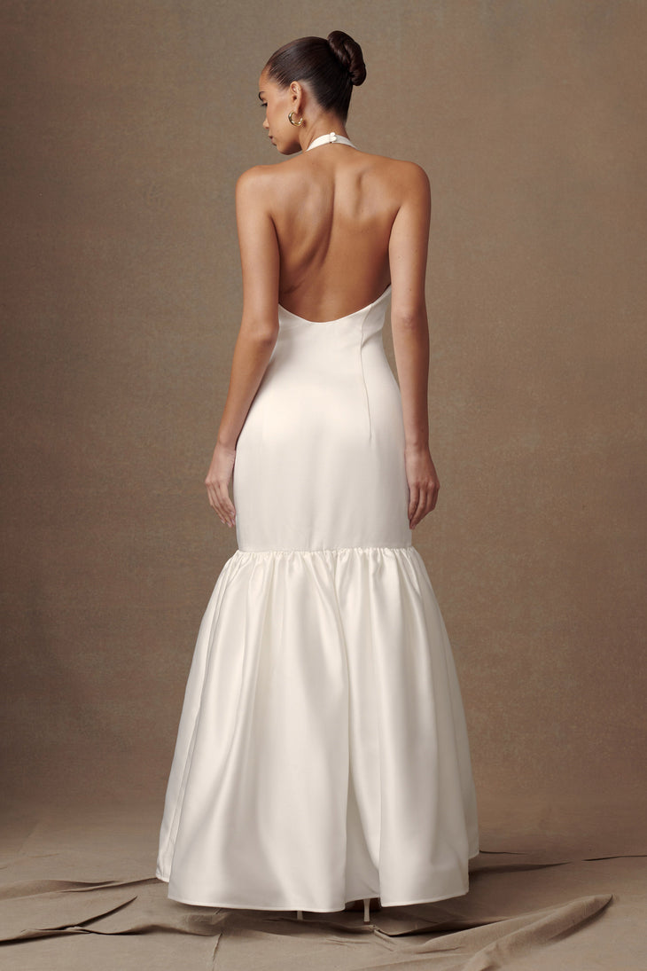 Elegant white halter neck gown with open back and tiered mermaid skirt — Meshki | Endless UAE