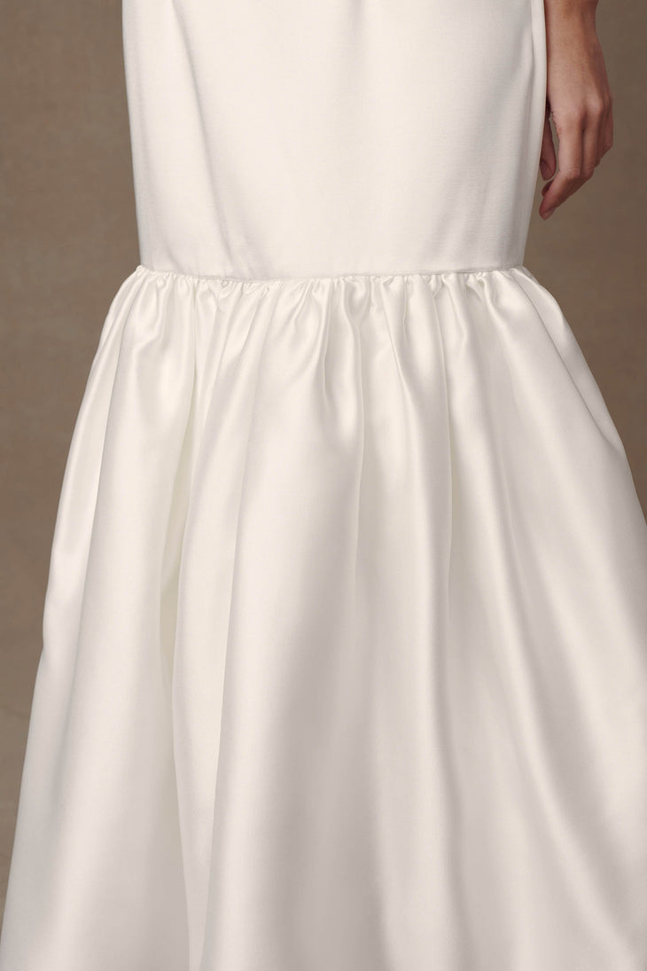 Close-up of white satin halter gown with gathered waist and flowing A-line skirt — Meshki | Endless UAE