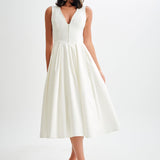 Woman wearing cream sleeveless midi dress with button front — Meshki | Endless UAE