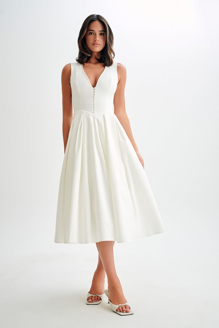 Woman wearing cream sleeveless midi dress with button front — Meshki | Endless UAE