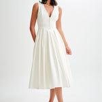 Woman wearing cream sleeveless midi dress with button front — Meshki | Endless UAE