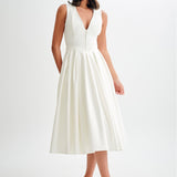 Woman wearing cream sleeveless midi dress with button front — Meshki | Endless UAE