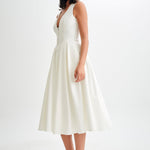 Woman wearing cream sleeveless midi dress with button front — Meshki | Endless UAE