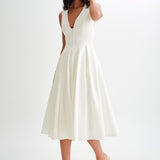 Woman wearing cream sleeveless midi dress with button front — Meshki | Endless UAE