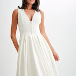 Woman wearing cream sleeveless midi dress with button front — Meshki | Endless UAE