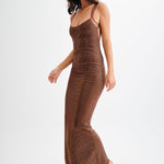 Jasmyn Hot Fix Maxi Dress With Mesh Back in bronze worn by woman against beach backdrop — Meshki | Endless UAE