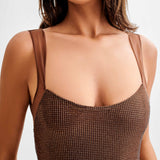 Jasmyn Hot Fix Maxi Dress With Mesh Back in bronze worn by woman against beach backdrop — Meshki | Endless UAE