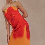 Woman wearing a strapless orange and red ombre chiffon maxi dress with gold hoop earrings — Meshki | Endless UAE