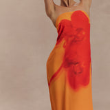 Woman wearing a strapless orange and red ombre chiffon maxi dress with gold hoop earrings — Meshki | Endless UAE